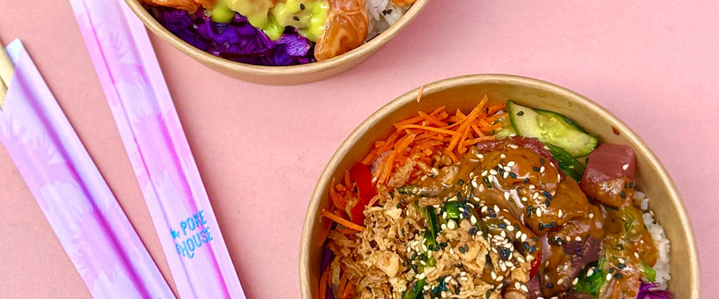 Poke bowl and chopsticks on a pink background