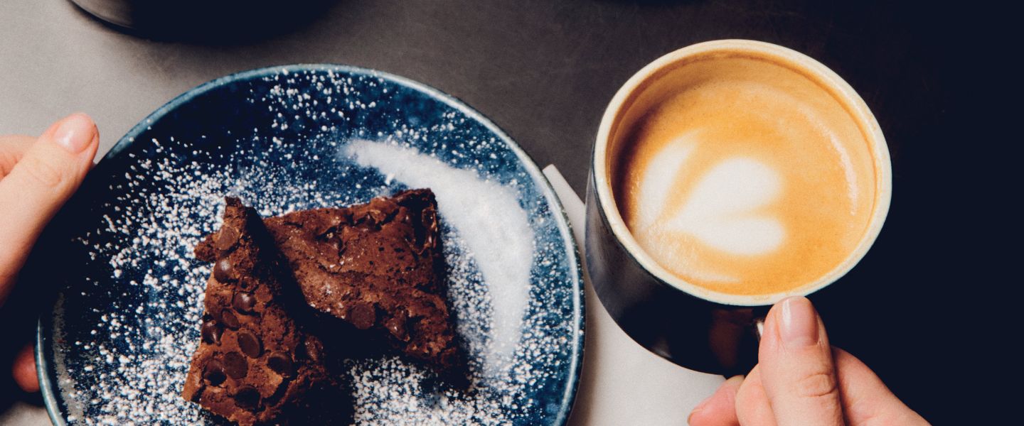 A chocolate cake slice and a mug of coffee