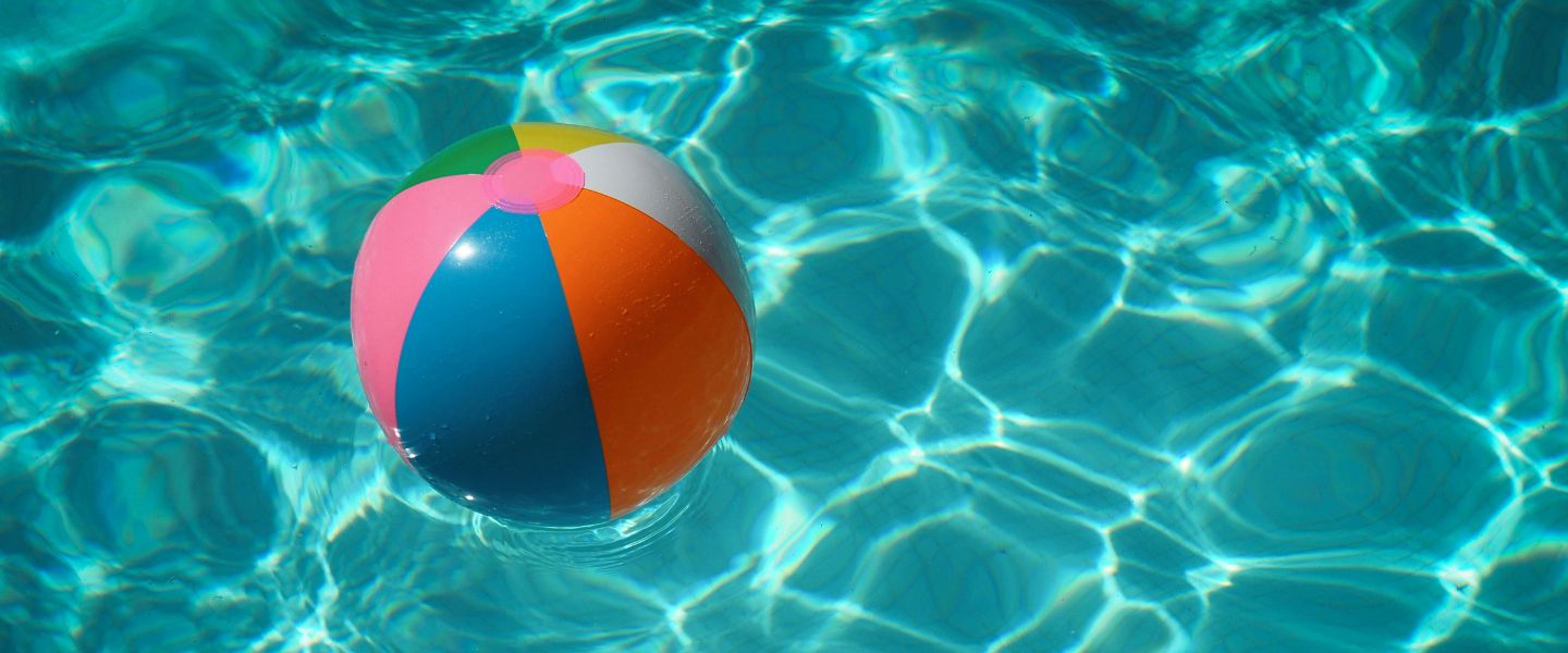 A beach ball in a blue pool
