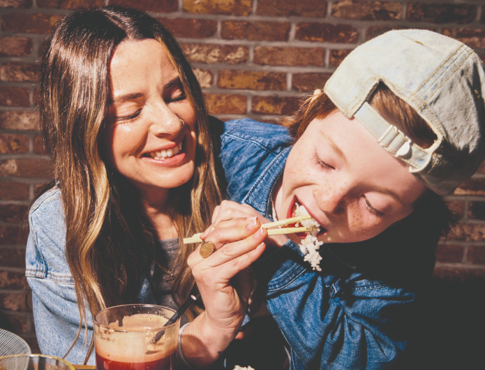 Woman and child eating and laughing