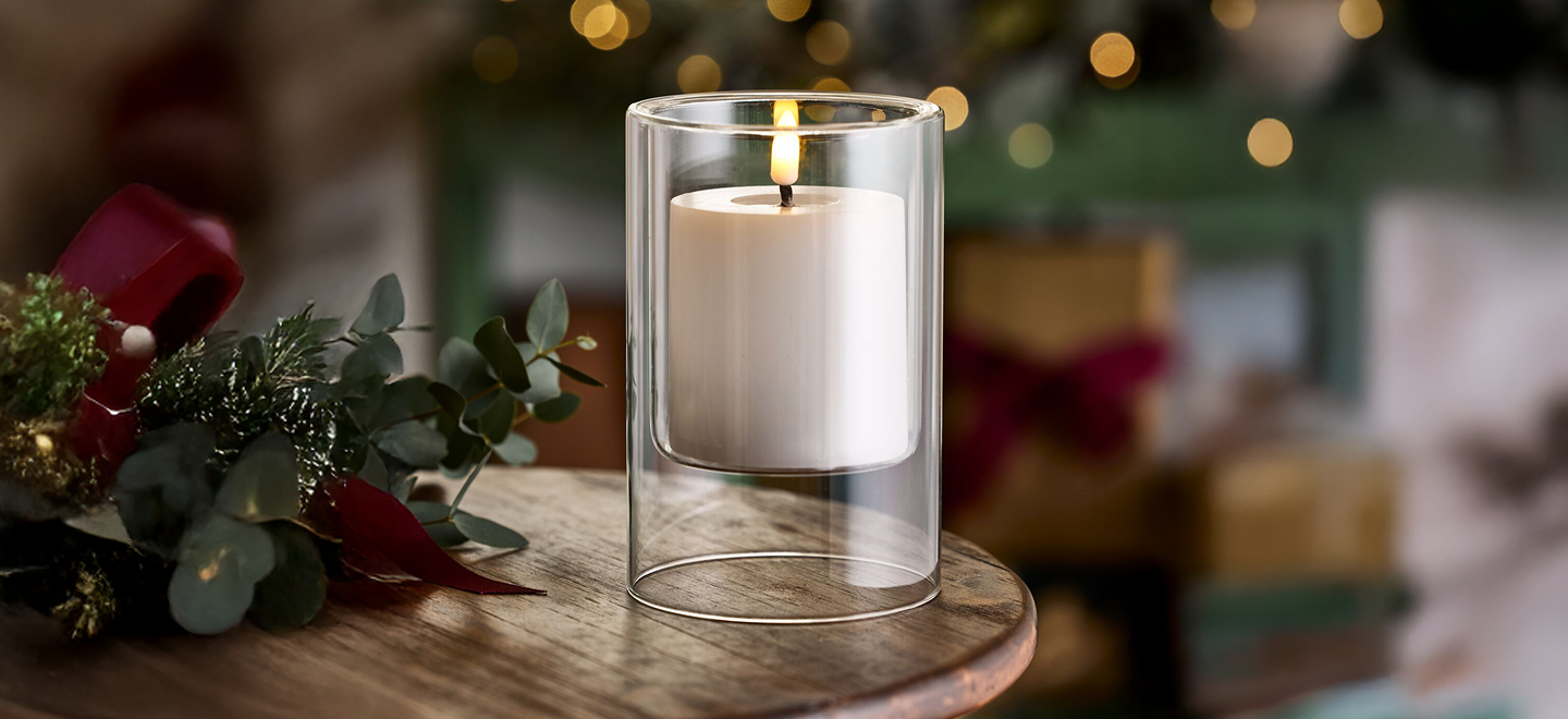 A Lakeland hurricane candle against a Christmas backdrop