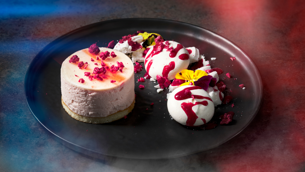 A cheesecake and ice cream topped with fruit from F1 Arcade