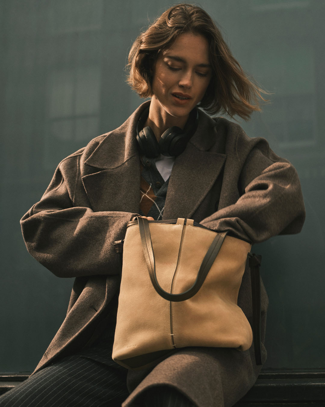 A female model with a light brown bag from Radley London