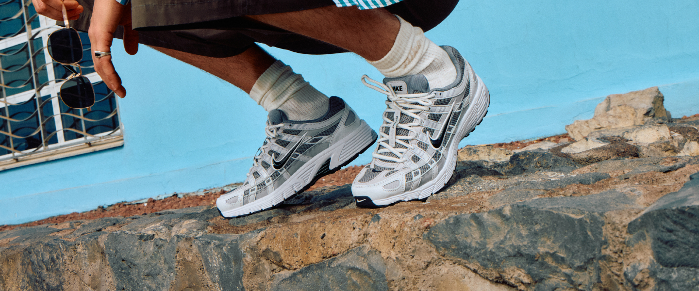 Person crouching wearing trainers