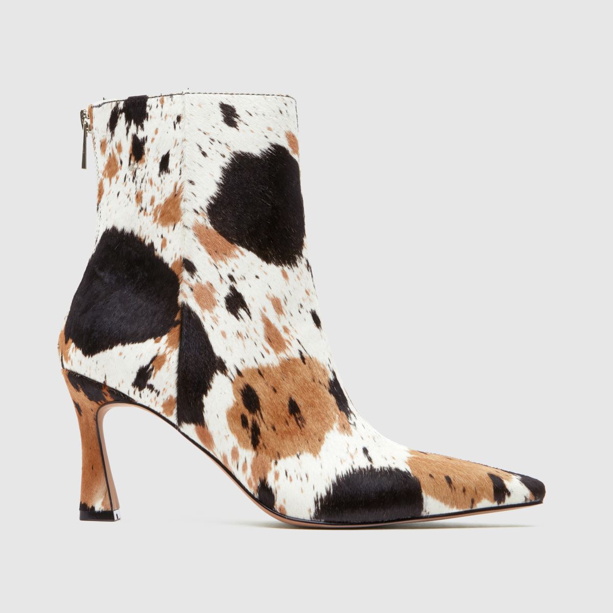A cow print heeled ankle boot