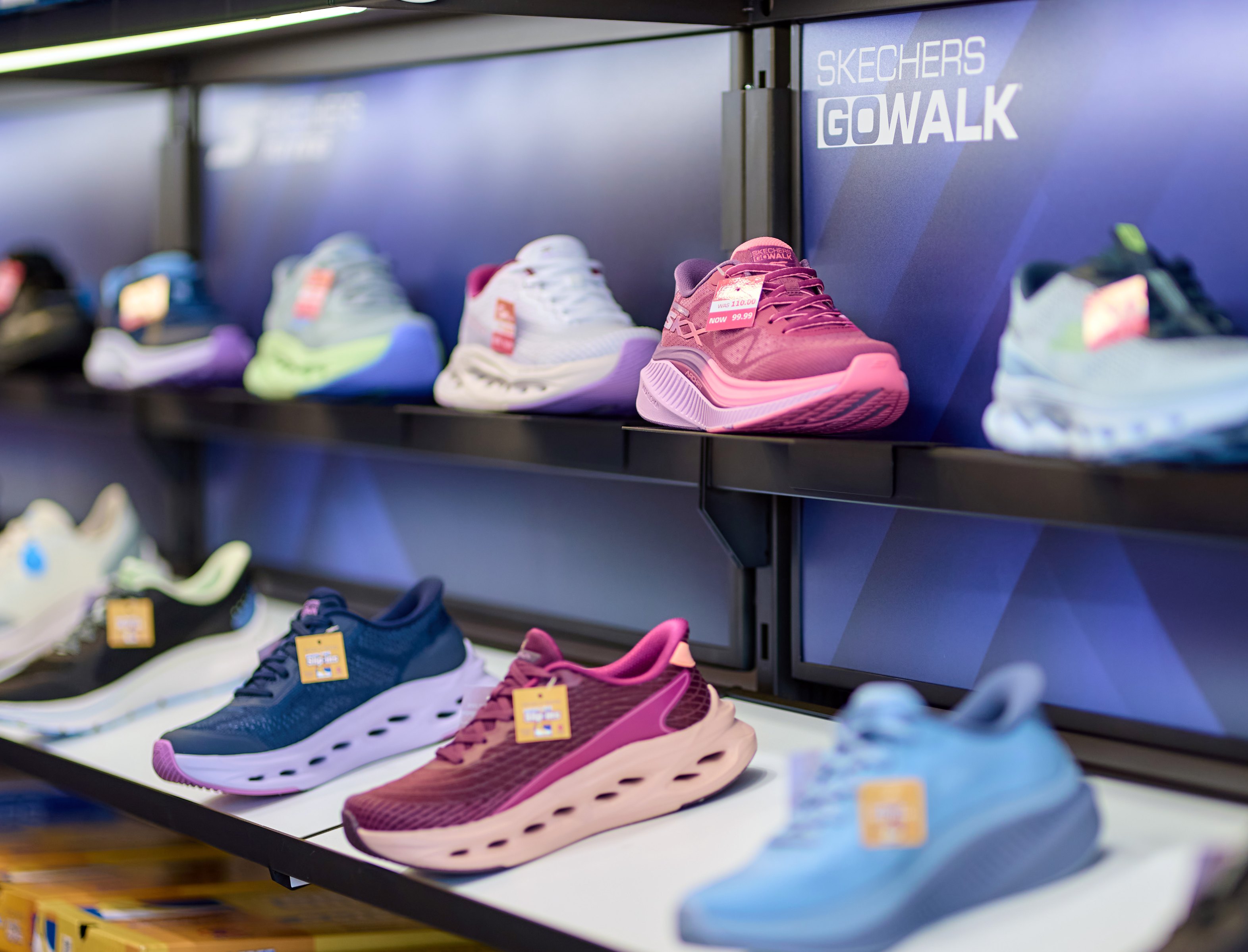 Multi-coloured trainers pictured in a Skechers store