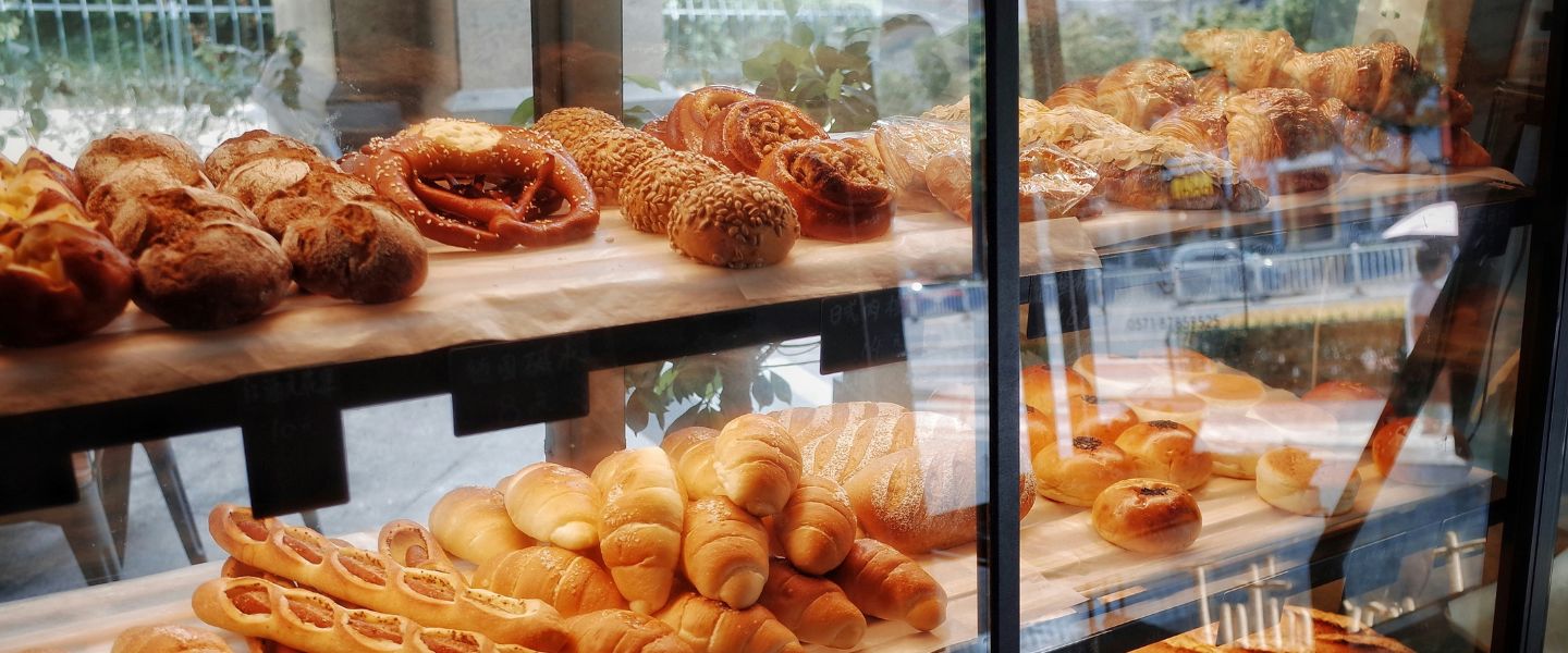 A bakery window with pastries and bread on display