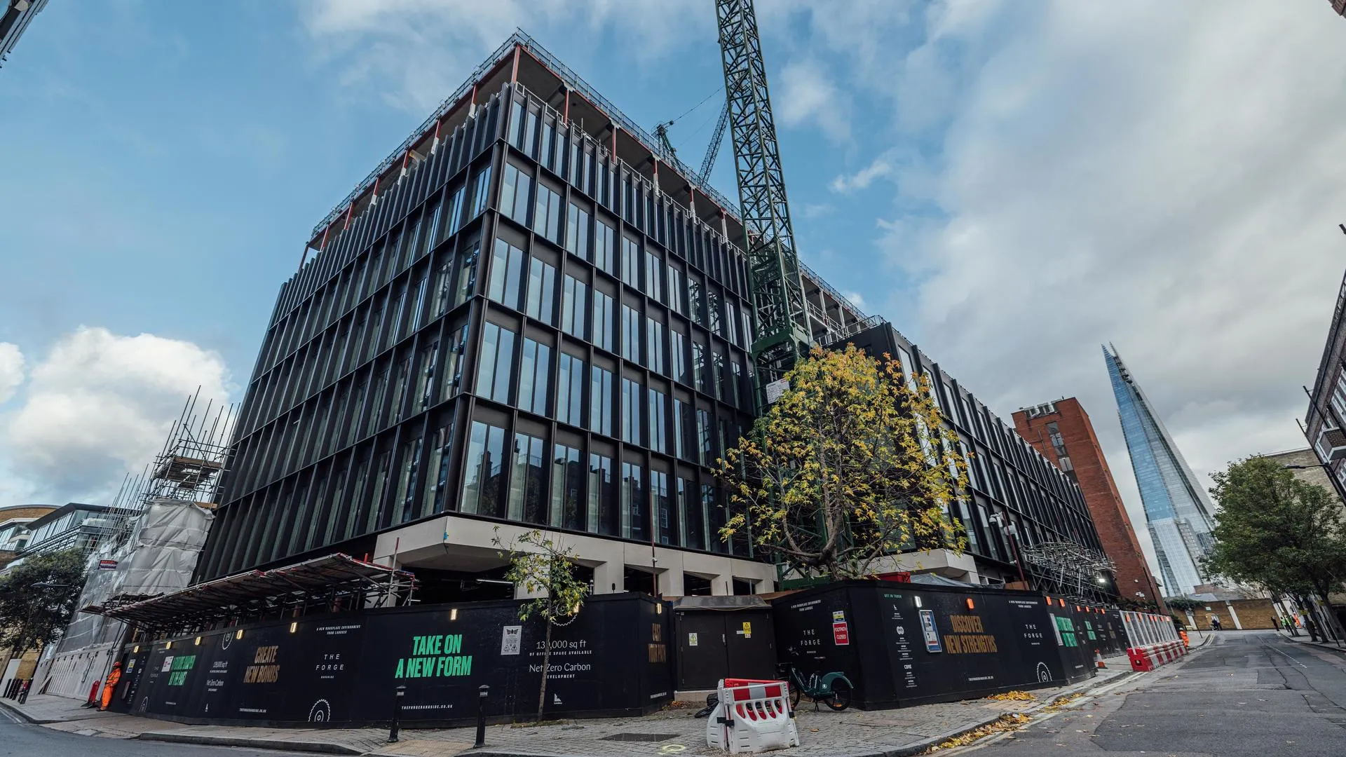The Forge: A 13,000 sq ft Net Zero Carbon development building under construction with a crane and scaffolding.