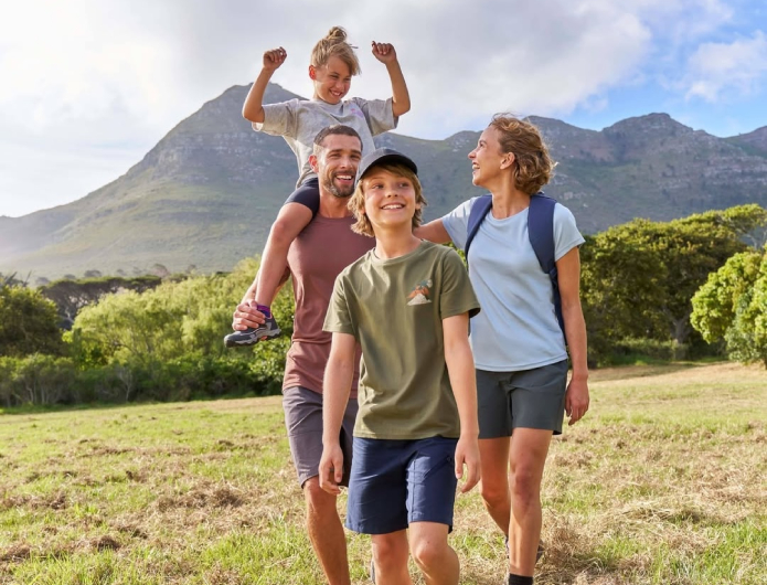 A family of four walking in the countryside