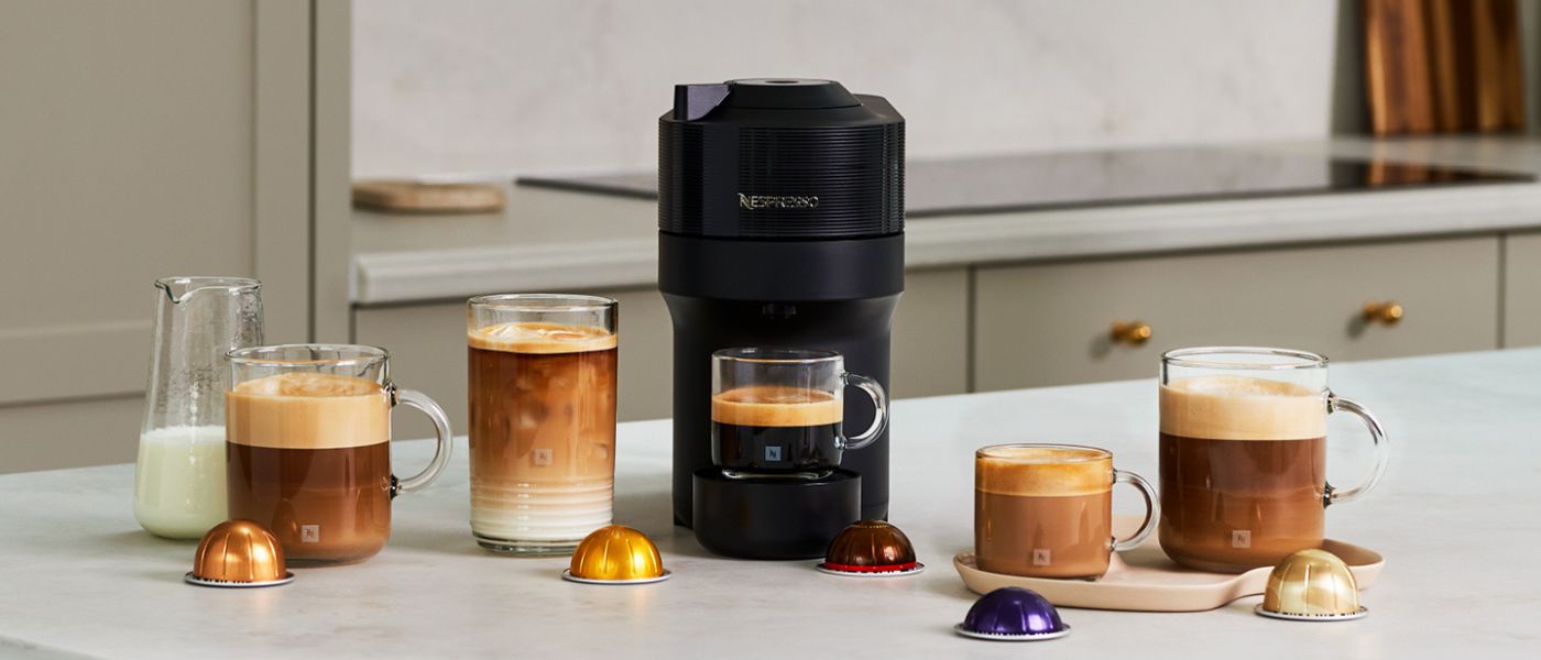 Nespresso Vertuo machine surrounded by coffee cups