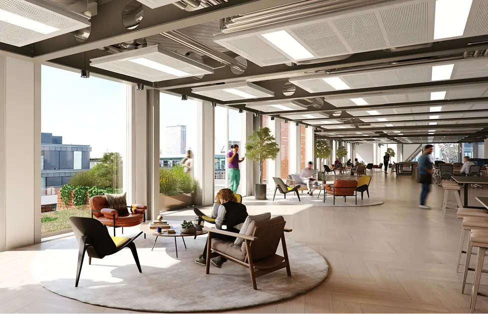 Modern flexible office workspace with lounge seating, large windows, and an open-plan design.