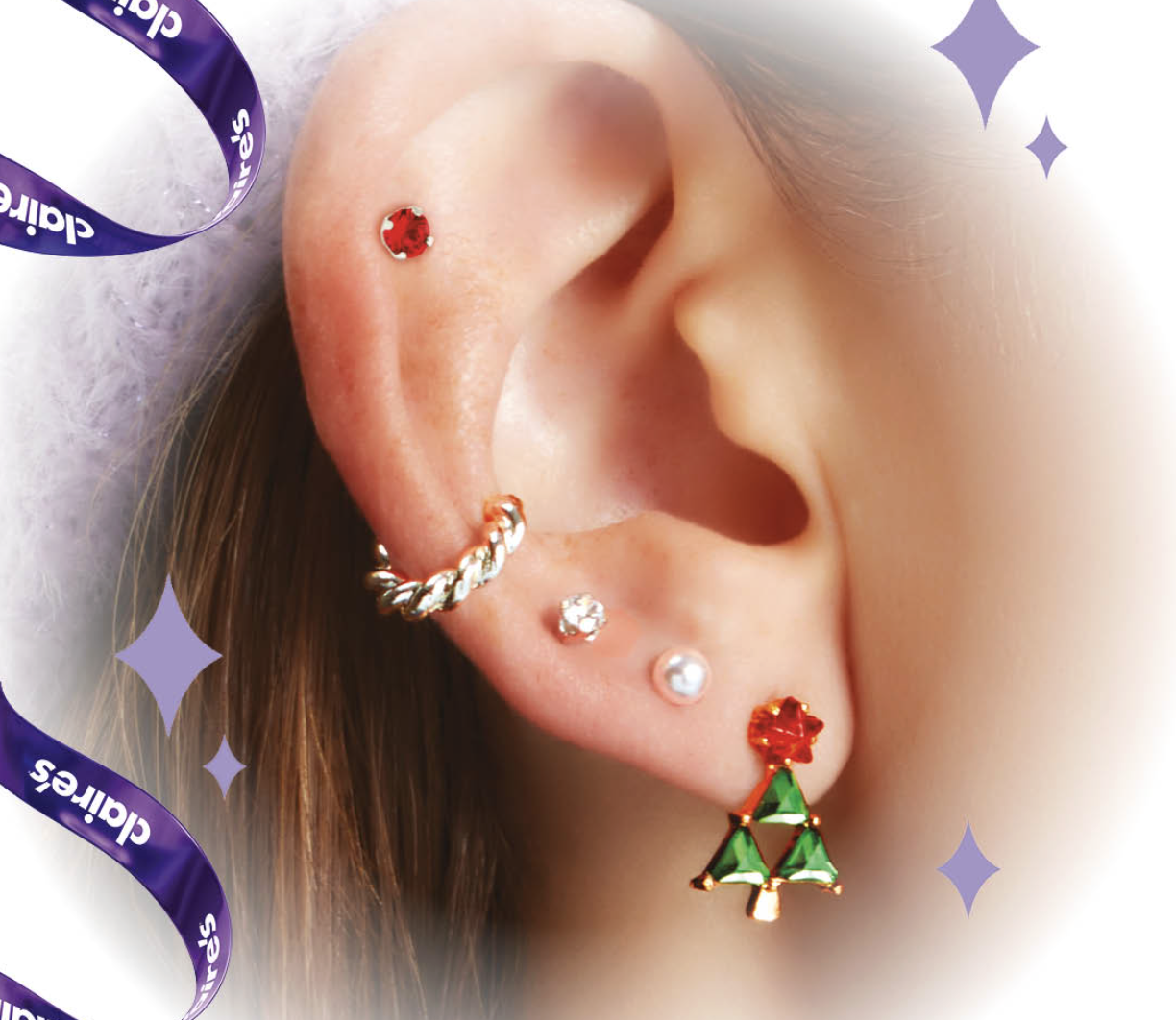 An ear with five different earrings 