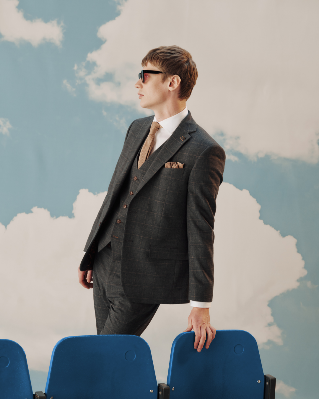 A model wearing a grey three-piece suit