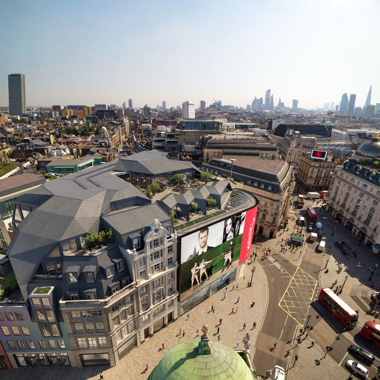 Aerial view of a busy city street and building with large advertisements.